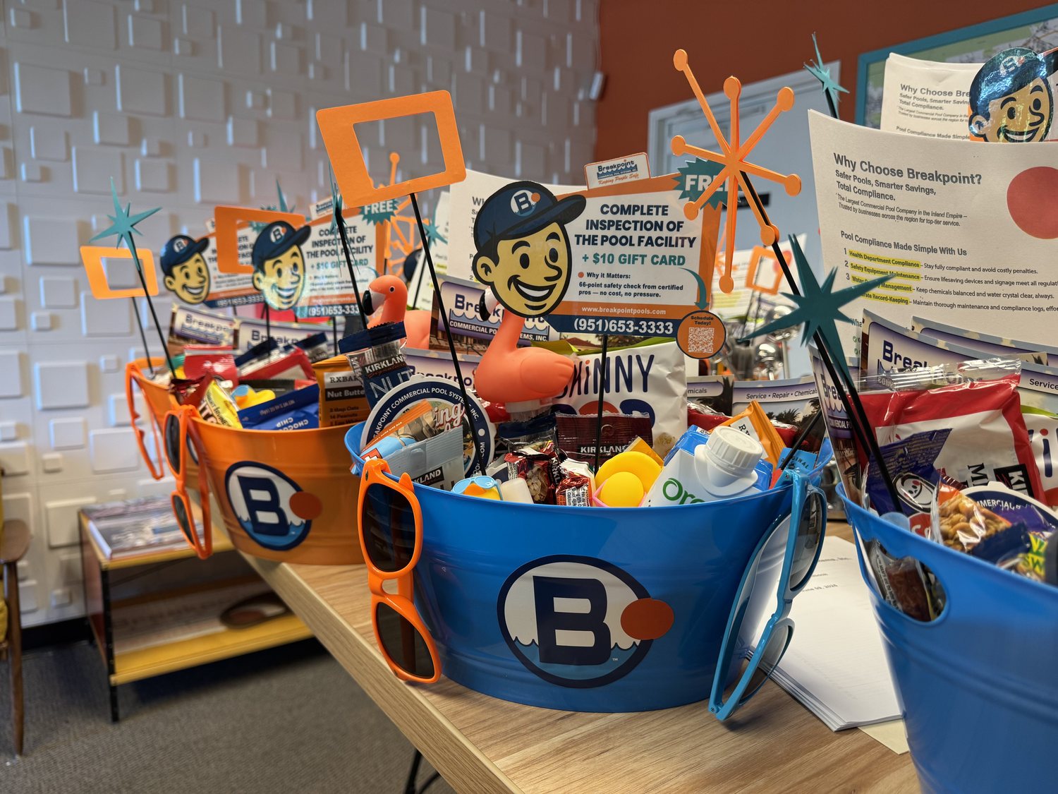 Breakpoint branded gift baskets — B-bucket tubs with snacks, sunglasses and free inspection cards